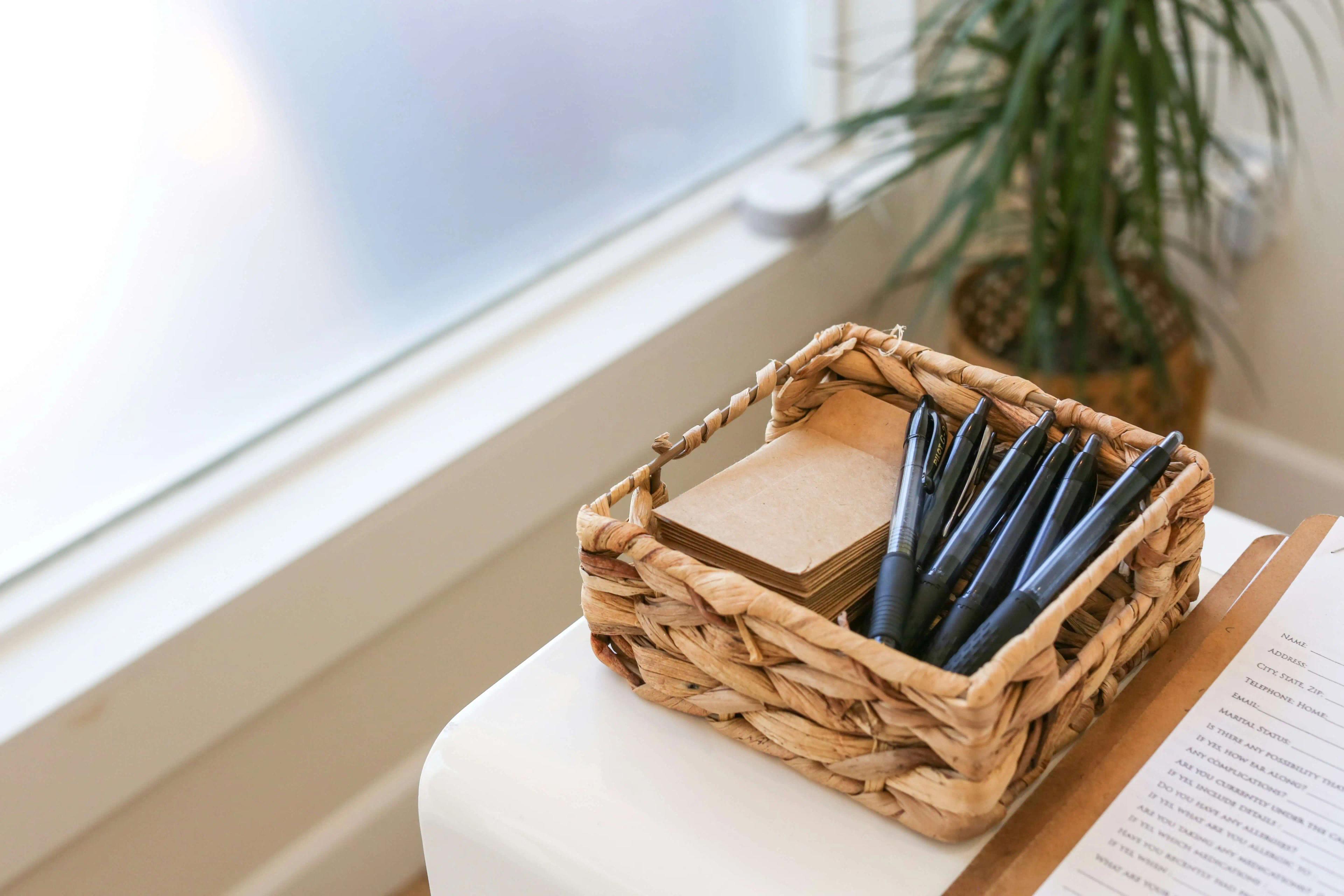 Basket filled with pens and forms